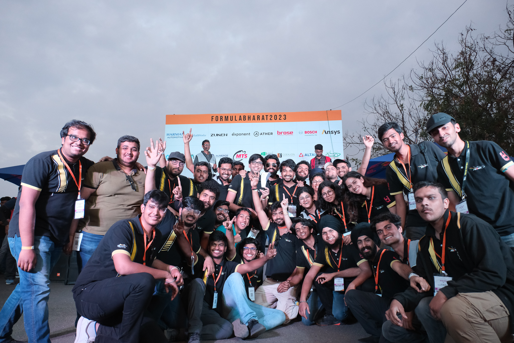 Team Fateh celebrating their national Statics win in front of the Formula Bharat 2023 board